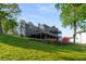 Lush backyard featuring multiple levels, with decks and a patio perfect for enjoying the outdoors at 6477 Old Shadburn Ferry Rd, Buford, GA 30518