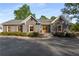 Attractive home featuring a driveway, manicured landscaping, and shutters at 6477 Old Shadburn Ferry Rd, Buford, GA 30518