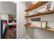 Hallway view of a bunk room showcasing custom shelving and unique decor at 6477 Old Shadburn Ferry Rd, Buford, GA 30518