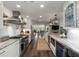 Open gourmet kitchen featuring stainless steel appliances, wine storage, and eat-in island at 6477 Old Shadburn Ferry Rd, Buford, GA 30518