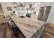 Open kitchen features a large island with counter seating, stainless steel appliances, and modern lighting at 6477 Old Shadburn Ferry Rd, Buford, GA 30518