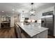 A kitchen with stainless steel appliances, granite countertops, and modern pendant lighting at 6477 Old Shadburn Ferry Rd, Buford, GA 30518