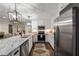 Bright kitchen with granite countertops, stainless appliances, white cabinetry, and modern pendant lighting at 6477 Old Shadburn Ferry Rd, Buford, GA 30518