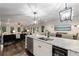 Open kitchen featuring a large island, modern appliances, and seamless flow into the adjacent living room at 6477 Old Shadburn Ferry Rd, Buford, GA 30518