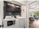 A well-organized laundry area with modern machines, shelving, and a unique decorative wallpaper at 6477 Old Shadburn Ferry Rd, Buford, GA 30518