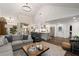 Open concept living room and kitchen featuring shiplap, stainless steel appliances, and wood floors at 6477 Old Shadburn Ferry Rd, Buford, GA 30518