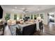 Bright living room featuring hardwood floors, many windows, comfortable seating, and a ceiling fan at 6477 Old Shadburn Ferry Rd, Buford, GA 30518