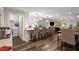 Open concept living, dining, and kitchen area with breakfast bar and stainless steel appliances at 6477 Old Shadburn Ferry Rd, Buford, GA 30518