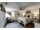 Well-lit main bedroom with hardwood floors, neutral colors, ceiling fan, sitting area, and access to outdoor space at 6477 Old Shadburn Ferry Rd, Buford, GA 30518