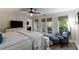 This is a spacious main bedroom featuring a ceiling fan, large dresser, and French doors to the outside deck at 6477 Old Shadburn Ferry Rd, Buford, GA 30518