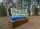 Margaritaville at Lanier Islands welcomes visitors with a large sign near lush pine trees at 6477 Old Shadburn Ferry Rd, Buford, GA 30518
