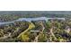 Aerial shot of beautiful home nestled in a lush, green community near a lake and golf course at 1010 Lake Shore Overlook, Alpharetta, GA 30005