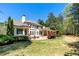 Expansive backyard with a large patio and well-manicured lawn; features a large white home at 1010 Lake Shore Overlook, Alpharetta, GA 30005