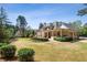 Expansive backyard featuring a sprawling lawn, patio, and a large home with neutral finishes at 1010 Lake Shore Overlook, Alpharetta, GA 30005