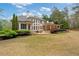 A beautiful backyard with a patio and lush green grass surrounded by trees at 1010 Lake Shore Overlook, Alpharetta, GA 30005