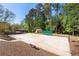 Enjoy a private outdoor basketball court surrounded by trees for recreational activities and fitness at 1010 Lake Shore Overlook, Alpharetta, GA 30005