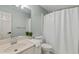 Neutral bathroom with a single sink vanity, toilet, and a shower with white curtain at 1010 Lake Shore Overlook, Alpharetta, GA 30005
