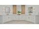 Bright bathroom featuring a double sink vanity with white cabinets and modern gold fixtures and decorative mirrors at 1010 Lake Shore Overlook, Alpharetta, GA 30005