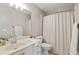 Neutral bathroom featuring a single sink vanity, toilet, and a shower with curtain at 1010 Lake Shore Overlook, Alpharetta, GA 30005
