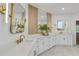 Bright bathroom with a double vanity, decorative mirrors, modern fixtures, and a tiled accent wall at 1010 Lake Shore Overlook, Alpharetta, GA 30005