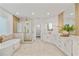 Large bathroom featuring a soaking tub, glass shower, white vanity with double sinks, and access to walk-in closet at 1010 Lake Shore Overlook, Alpharetta, GA 30005