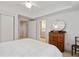 Bright bedroom featuring a ceiling fan, white walls and trim, and a vintage dresser at 1010 Lake Shore Overlook, Alpharetta, GA 30005