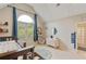 Bright bedroom featuring a vaulted ceiling, a large arched window, and neutral walls at 1010 Lake Shore Overlook, Alpharetta, GA 30005