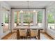 Dining area features a table with seating for four and a view to the outdoor living space at 1010 Lake Shore Overlook, Alpharetta, GA 30005