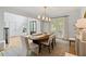 Elegant dining room with hardwood floors, modern lighting, and french doors to the outside at 1010 Lake Shore Overlook, Alpharetta, GA 30005