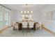 Bright dining room featuring a large oval table, modern chandelier, and french doors at 1010 Lake Shore Overlook, Alpharetta, GA 30005