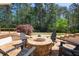 Backyard with cozy stone fire pit and seating area, perfect for outdoor gatherings at 1010 Lake Shore Overlook, Alpharetta, GA 30005