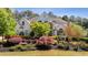 Beautiful white house featuring professionally landscaped yard and a symmetrical facade at 1010 Lake Shore Overlook, Alpharetta, GA 30005