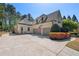 Beautiful home featuring a three-car garage, lush landscaping, and charming curb appeal at 1010 Lake Shore Overlook, Alpharetta, GA 30005