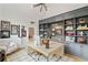 Spacious home office with custom built-in shelving, modern desk, and a comfortable sitting area at 1010 Lake Shore Overlook, Alpharetta, GA 30005