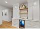 Custom kitchen features white cabinetry, a built-in wine fridge, open shelving, and luxurious countertop at 1010 Lake Shore Overlook, Alpharetta, GA 30005