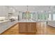 Beautiful kitchen with island seating, a view of the living room, and plentiful natural light at 1010 Lake Shore Overlook, Alpharetta, GA 30005