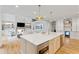 Open-concept kitchen boasts a large island, stainless steel appliances, and seamless flow into the adjacent living space at 1010 Lake Shore Overlook, Alpharetta, GA 30005