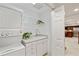 This laundry room features a stacked washer/dryer, white cabinets, and a sink at 1010 Lake Shore Overlook, Alpharetta, GA 30005