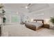 Spacious main bedroom with sitting area, tray ceilings, and large windows offering serene views at 1010 Lake Shore Overlook, Alpharetta, GA 30005