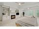 Spacious main bedroom with fireplace, built-in shelving, tray ceilings, and abundant natural light at 1010 Lake Shore Overlook, Alpharetta, GA 30005
