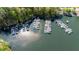 Aerial view of marina with multiple docks and boats on a sunny day surrounded by lush green trees and sparkling water at 1010 Lake Shore Overlook, Alpharetta, GA 30005