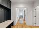 Hallway featuring custom mudroom storage bench and hanging lockers with hardwood floors at 1010 Lake Shore Overlook, Alpharetta, GA 30005