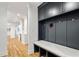 Mudroom hallway featuring custom storage bench and hanging lockers with hardwood floors at 1010 Lake Shore Overlook, Alpharetta, GA 30005