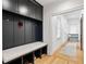 Mudroom featuring custom storage bench and hanging lockers with hardwood floors leading to the hallway at 1010 Lake Shore Overlook, Alpharetta, GA 30005