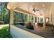 Covered patio featuring outdoor kitchen area with a built-in grill and sink, dining and views of yard at 1010 Lake Shore Overlook, Alpharetta, GA 30005