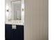Stylish powder room featuring navy vanity with gold accents, bright lighting, and elegant wallpaper at 1010 Lake Shore Overlook, Alpharetta, GA 30005