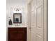This powder room has a granite counter, updated lighting, and a dark wood vanity at 1010 Lake Shore Overlook, Alpharetta, GA 30005