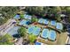 Overhead view of numerous well-maintained tennis courts next to parking surrounded by mature trees at 1010 Lake Shore Overlook, Alpharetta, GA 30005