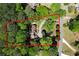 This aerial view shows the home's expansive lot, circular drive, and mature trees at 1745 Shady Hill Ne Rd, Marietta, GA 30068