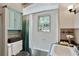 Bathroom with shower over tub combination with white tiles and neutral walls at 1745 Shady Hill Ne Rd, Marietta, GA 30068